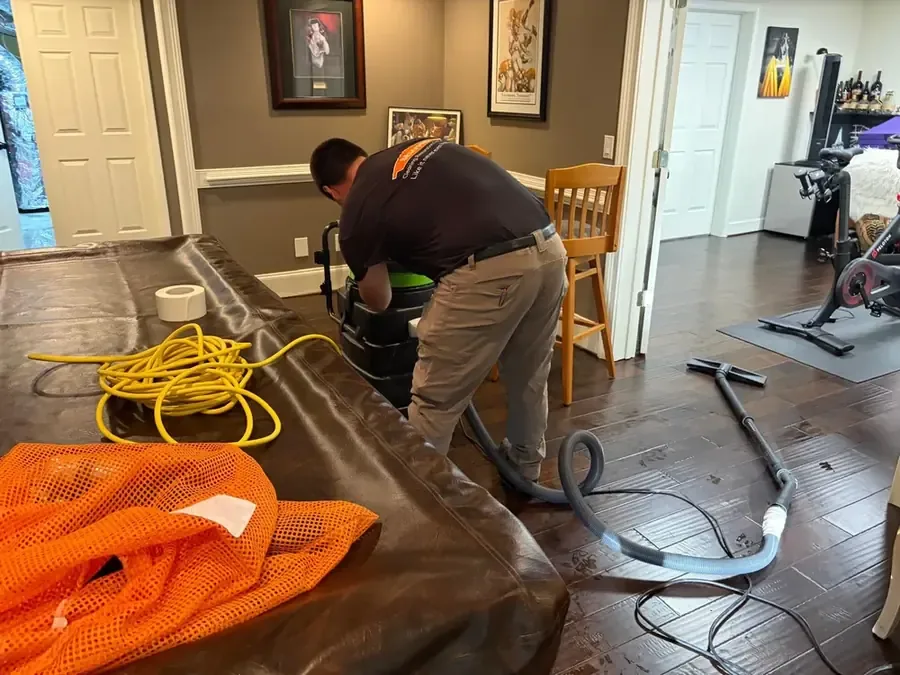 Water being pumped out of a basement after a sump failure