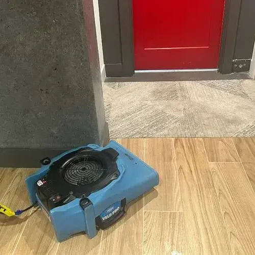 Air mover drying a tile floor near a doorway, Harper Woods