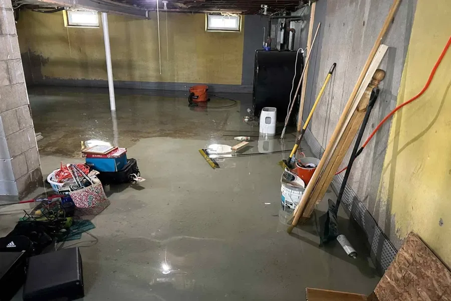 Cleanup of a flooded basement floor inside a home